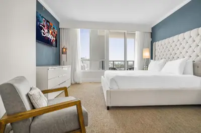 a bedroom with a large white bed and a chair at FontaineBleau Suite Ocean View in Miami Beach