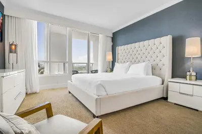 a bedroom with a white bed and a large window at FontaineBleau Suite Ocean View in Miami Beach