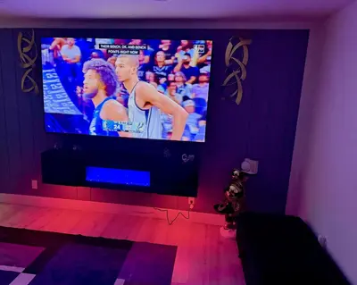a tv in a room with a purple wall at Serene 3-Bedroom renovated house with AC in Fort Lauderdale in Fort Lauderdale