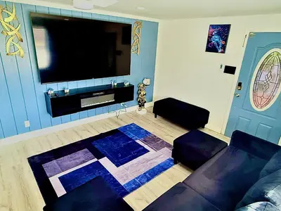 a living room with a couch and a flat screen tv at Serene 3-Bedroom renovated house with AC in Fort Lauderdale in Fort Lauderdale