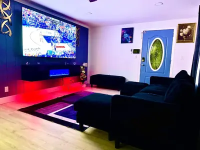 a living room with a couch and a large screen tv at Serene 3-Bedroom renovated house with AC in Fort Lauderdale in Fort Lauderdale