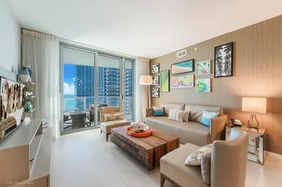 a living room with a couch and a table at LYFE Resort Ocean View Penthouse in Hollywood