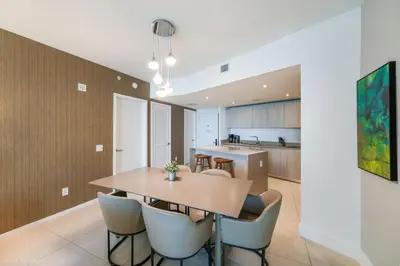 a dining room and kitchen with a table and chairs at LYFE Resort Ocean View Penthouse in Hollywood