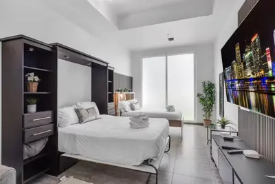 a bedroom with a bed and a desk at Cozy Studio in Brickell free parking in Miami