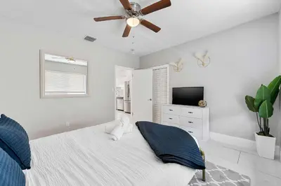 a bedroom with a bed and a ceiling fan at Modern 3 BR Villa Near Beach & FLL in Hollywood