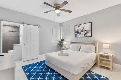 a bedroom with a bed and a ceiling fan at Modern 3 BR Villa Near Beach & FLL in Hollywood