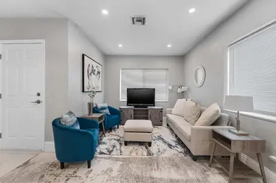 a living room with a couch and a tv at Modern 3 BR Villa Near Beach & FLL in Hollywood