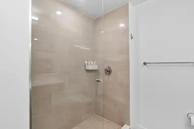 a shower with a glass door in a bathroom at Luxury Pent House Suite with Downtown Views in Miami