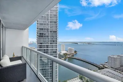 an apartment balcony with a view of the water at W hotel High end ocean view 2 bedroom at icon brickell in Miami
