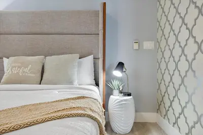 a bedroom with a bed with a headboard and a lamp at W hotel High end ocean view 2 bedroom at icon brickell in Miami