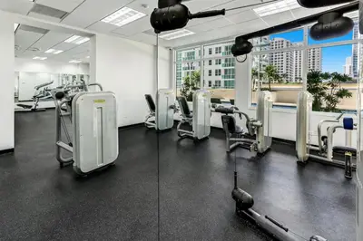 a gym with treadmills and machines in a building at Stylish Renovated 3BR Condo Bay Views plus Parking in Miami