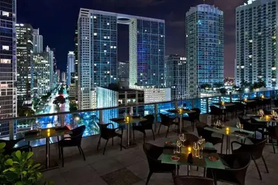 a restaurant with tables and chairs on the roof of a building at Stylish Renovated 3BR Condo Bay Views plus Parking in Miami