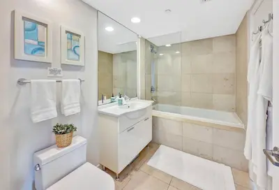 a bathroom with a toilet and a sink and a tub at Icon Brickell 20th Floor 1BR Pool View Balcony in Miami