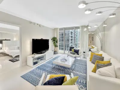 a living room with a couch and a tv at Icon Brickell 20th Floor 1BR Pool View Balcony in Miami