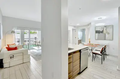 a kitchen and a living room with a dining room at Chic 2BR Edgewater Condo with Views plus Balcony in Miami