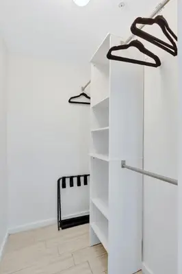 a white wardrobe in a room with white walls at Chic 2BR Edgewater Condo with Views plus Balcony in Miami