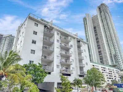 a white apartment building with two tall buildings at Chic 2BR Edgewater Condo with Views plus Balcony in Miami