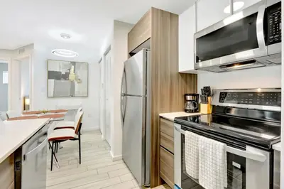 a kitchen with stainless steel appliances and a counter top at Chic 2BR Edgewater Condo with Views plus Balcony in Miami