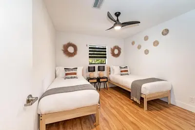 a bedroom with two beds and a ceiling fan at Fox Garden Luxury Boho Near Downtown & Beach in Fort Lauderdale