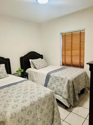 a bedroom with two beds and a window at Love Story Pool House, free parking & BBQ in Miami