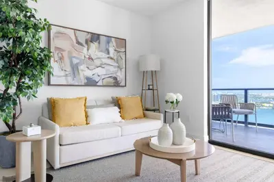 a living room with a white couch and a table at 2916 Heart of Downtown Apt with Gym a Pool and a Coworking Space in Miami