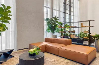 a living room with a brown couch and a table at 2916 Heart of Downtown Apt with Gym a Pool and a Coworking Space in Miami