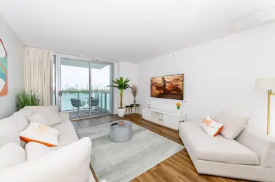 a living room with white furniture and a large window at 2 King Rooms Mondrian Resort Skyline Bay Balcony in Miami Beach