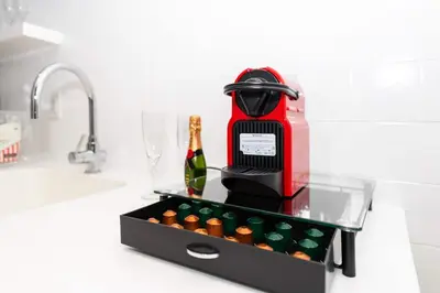 a kitchen counter with a bottle of wine and a mixer at 2 King Rooms Mondrian Resort Skyline Bay Balcony in Miami Beach