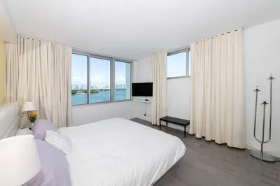 a white bedroom with a large bed and large windows at 2 King Rooms Mondrian Resort Skyline Bay Balcony in Miami Beach