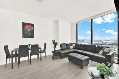 a living room with a couch and a table at Ocean Front Condo Near Cruise Port, Bayfront Park, plus Free Parking in Miami