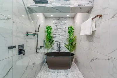 a bathroom with a large tub and a plant at Fox Private Resort- Near Downtown & Beach in Fort Lauderdale