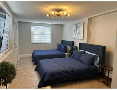 a bedroom with two beds and a couch at Studios & Coral Gable, close to downtown and airport in Miami