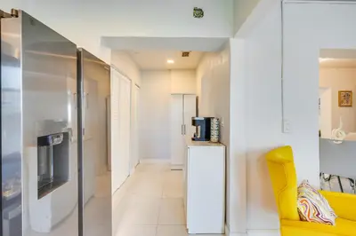 a living room with a refrigerator and a yellow chair at Walk to 2026 FIFA World Cup! Home with Spacious Yard in Miami