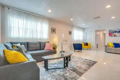 a living room with a couch and a table at Walk to 2026 FIFA World Cup! Home with Spacious Yard in Miami