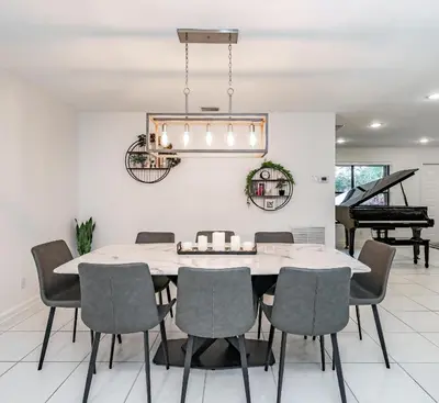 a dining room with a table and chairs and a piano at Fox Island Heated Spa- Downtown & Beach in Fort Lauderdale