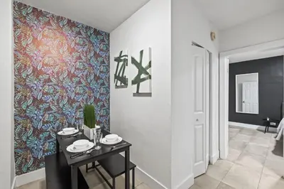 a hallway with a table and a colorful wall at Harding Apartments by Andes STR in Miami Beach