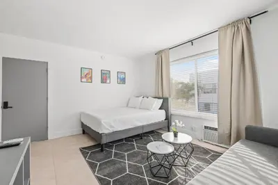 a living room with a bed and a couch at Harding Apartments by Andes STR in Miami Beach
