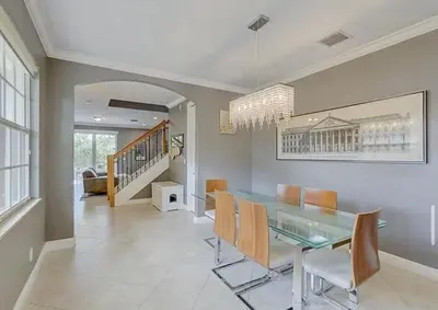 a dining room with a glass table and chairs at Family house with Heated Pool, Walk to Dining in Fort Lauderdale