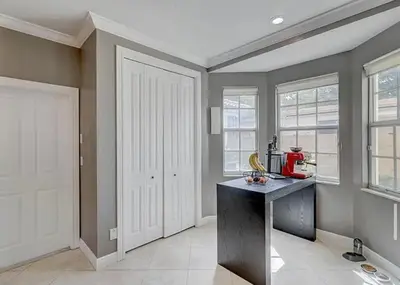 a kitchen with a counter and some windows at Family house with Heated Pool, Walk to Dining in Fort Lauderdale