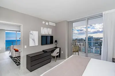 a bedroom with a bed and a desk with a television at Miami Escape 16th Floor – Near Hollywood Beach in Hollywood