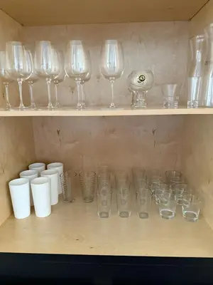 a shelf with wine glasses and cups on it at Stylish Miami Getaway in Miami