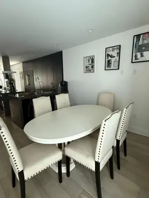 a white dining room table with chairs and a kitchen at Stylish Miami Getaway in Miami