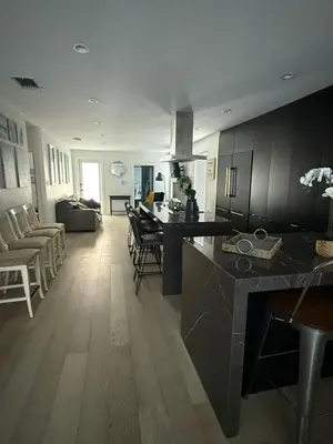 a kitchen and living room with a table and chairs at Stylish Miami Getaway in Miami