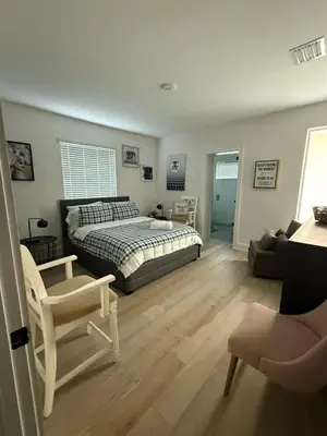 a bedroom with a bed and a chair at Stylish Miami Getaway in Miami