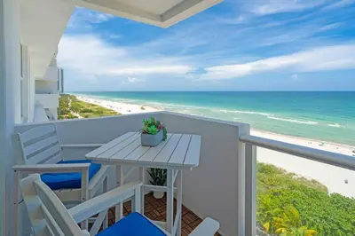 a balcony with a table and chairs and the beach at Elara Beachfront 2 Bedrooms Direct OceanView with Parking in Miami Beach