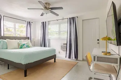 a bedroom with a bed and a ceiling fan at Your Modern South Florida Oasis Comfy and Central in Fort Lauderdale