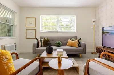 a living room with a couch and a tv at Your Modern South Florida Oasis Comfy and Central in Fort Lauderdale