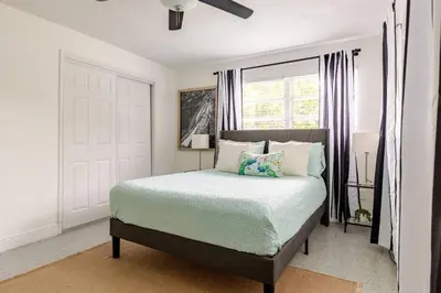 a bedroom with a bed and a window at Your Modern South Florida Oasis Comfy and Central in Fort Lauderdale