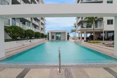 a swimming pool in the middle of a building at Luxury 1BR in Quadro Miami with Pool and Parking in Miami