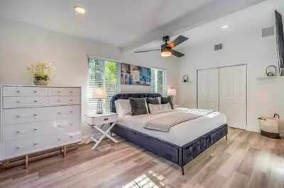 a bedroom with a bed and a dresser and a window at Friendly Fox Luxury Pool & Spa House Near Downtown & Beach in Fort Lauderdale